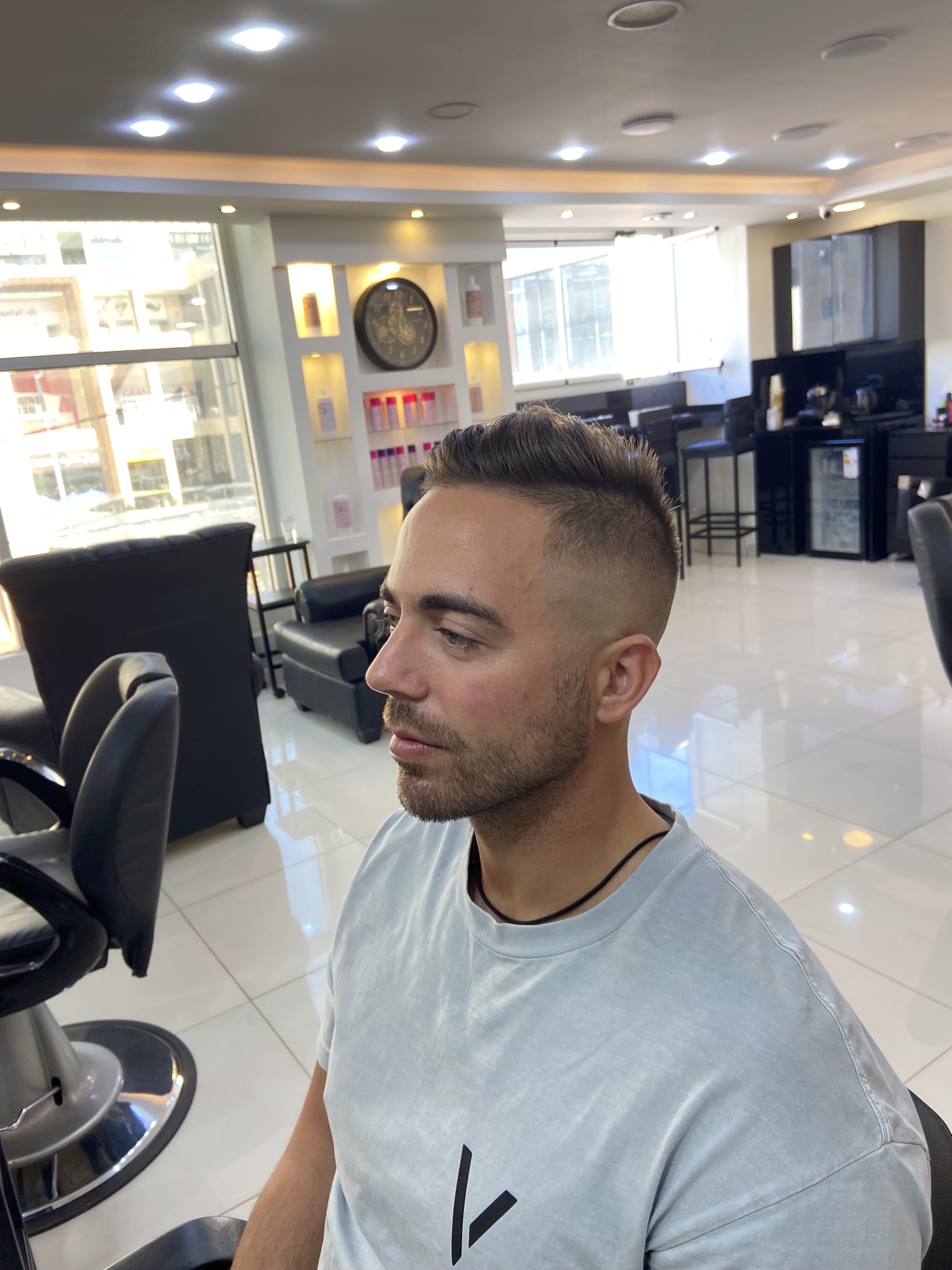 Mr. Black Barber Shop sleek white and black interior with high-gloss floors